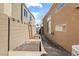 Functional side yard with garden beds and neutral-colored walls, offering potential for gardening and outdoor projects at 2163 Fountain Springs Dr, Henderson, NV 89074