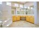 Luxurious primary bath featuring double sinks, a marble jacuzzi tub, and large mirrors at 2212 Sierra Heights Dr, Las Vegas, NV 89134