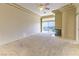 Large bedroom with plush carpeting, a modern fireplace, and a view of the city in the distance at 2212 Sierra Heights Dr, Las Vegas, NV 89134