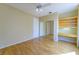 Comfortable bedroom with hardwood floors, built-in desk area, mirrored closet and ceiling fan at 2212 Sierra Heights Dr, Las Vegas, NV 89134