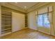 Cozy bedroom with Murphy bed, ample storage, hardwood floors, and a sunlit window at 2212 Sierra Heights Dr, Las Vegas, NV 89134