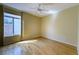 Bright bedroom featuring hardwood floors, a ceiling fan, and a large window with natural light at 2212 Sierra Heights Dr, Las Vegas, NV 89134