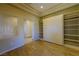 Bedroom featuring Murphy bed, wood floors, custom shelving, and natural light from window at 2212 Sierra Heights Dr, Las Vegas, NV 89134
