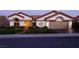 Dusk shot of a one-story home, tiled roof, manicured yard, and a two car garage at 2212 Sierra Heights Dr, Las Vegas, NV 89134