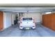 Well-lit garage with a car parked inside next to the water heater and features built-in storage cabinets at 2212 Sierra Heights Dr, Las Vegas, NV 89134