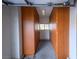 Extended garage with built-in wooden storage cabinets on both walls and a window that allows natural light inside at 2212 Sierra Heights Dr, Las Vegas, NV 89134