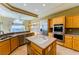 Well-equipped kitchen with stainless steel appliances, island sink, and breakfast bar at 2212 Sierra Heights Dr, Las Vegas, NV 89134