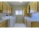 Spacious laundry room with white washer and dryer, ample counter space, and cabinet storage at 2212 Sierra Heights Dr, Las Vegas, NV 89134