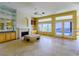 Open living room with a fireplace, built-in cabinets, marble floors, and a view of the pool at 2212 Sierra Heights Dr, Las Vegas, NV 89134