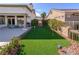 Backyard putting green, lush landscaping, patio, and outdoor dining area for entertaining and relaxing at 2212 Sierra Heights Dr, Las Vegas, NV 89134