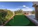Putting green in backyard with manicured shrubs and beautiful valley views at 2212 Sierra Heights Dr, Las Vegas, NV 89134