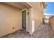 A private backyard access with paved walkway and neutral stucco wall allows for easy outdoor transitions at 228 Via Vallisneri, Henderson, NV 89011