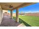 Enjoy the spacious backyard patio with lush synthetic grass and covered entertaining space with mountain views at 228 Via Vallisneri, Henderson, NV 89011