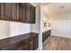 Bathroom featuring dual sinks, dark cabinets, and modern fixtures at 228 Via Vallisneri, Henderson, NV 89011