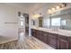 Bathroom features a double vanity, modern lighting, and a separate tub and shower area at 228 Via Vallisneri, Henderson, NV 89011