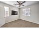 A bedroom with neutral carpet, ceiling fan and two windows allowing for natural light to fill the space at 228 Via Vallisneri, Henderson, NV 89011