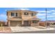Two-story home with a three-car garage, desert landscaping, and a decorative tiled roof at 228 Via Vallisneri, Henderson, NV 89011