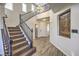 Grand foyer with staircase, wood-look tile flooring, and abundant natural light with direct access to upper floor at 228 Via Vallisneri, Henderson, NV 89011