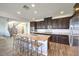 Modern kitchen with granite island, stainless appliances, and a beautiful staircase at 228 Via Vallisneri, Henderson, NV 89011