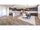Open kitchen and dining area with stainless appliances, granite countertops, and ample seating at 228 Via Vallisneri, Henderson, NV 89011
