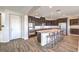 Modern kitchen features dark cabinets, stainless steel appliances, and a large center island with seating at 228 Via Vallisneri, Henderson, NV 89011