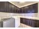 A spacious laundry room features modern appliances and ample cabinet space for easy organization at 228 Via Vallisneri, Henderson, NV 89011