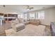 Spacious living room with plush rug, open floorplan, and access to dining area at 228 Via Vallisneri, Henderson, NV 89011