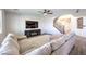 Open living room with contemporary furnishings, large sectional, and staircase access at 228 Via Vallisneri, Henderson, NV 89011