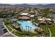 Community pool with plenty of shade surrounded by palm trees and lounge chairs in a desert oasis at 228 Via Vallisneri, Henderson, NV 89011