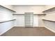 Walk-in closet with built-in shelving and carpeted flooring at 228 Via Vallisneri, Henderson, NV 89011