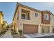 Charming townhome with a private balcony, a brown garage door, and a well-maintained front yard at 25 Barbara Ln # 38, Las Vegas, NV 89183