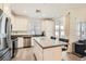 Modern kitchen features stainless steel appliances, white cabinets, and an island with bar seating at 25 Barbara Ln # 38, Las Vegas, NV 89183