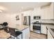 Bright kitchen features stainless steel appliances, white cabinets, and a cozy breakfast bar at 25 Barbara Ln # 38, Las Vegas, NV 89183