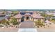 Expansive view of a well-manicured property featuring a solar-paneled roof, desert landscaping, and a luxurious pool at 274 Chartan Ave, Las Vegas, NV 89183