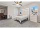 Bedroom with carpeted floor, murphy bed, fan, and ample natural light from the windows at 274 Chartan Ave, Las Vegas, NV 89183