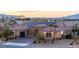 Expansive view of a well maintained home featuring a three car garage, paved drive and desert landscaping at 274 Chartan Ave, Las Vegas, NV 89183