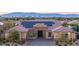 Beautiful single-story home featuring desert landscaping, solar panels, a brick driveway, and views of the Las Vegas skyline at 274 Chartan Ave, Las Vegas, NV 89183