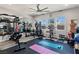 Bright home gym features ceiling fan, padded flooring, weight machines, and well-lit windows at 274 Chartan Ave, Las Vegas, NV 89183