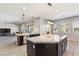 Open-concept kitchen with an island, pendant lighting, breakfast bar seating and stainless steel sink at 274 Chartan Ave, Las Vegas, NV 89183