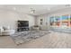 Large living area with wood-look tile floors, ceiling fan, and sliding glass doors to the outdoor space at 274 Chartan Ave, Las Vegas, NV 89183