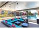 A covered patio boasts stylish outdoor seating and lighting, perfect for entertaining and poolside lounging at 274 Chartan Ave, Las Vegas, NV 89183