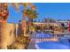 Inviting pool with cozy outdoor seating area and lush landscaping, perfect for relaxing evenings at 274 Chartan Ave, Las Vegas, NV 89183