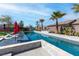 Stunning backyard pool with sunbeds surrounded by lovely landscaping and palm trees at 274 Chartan Ave, Las Vegas, NV 89183