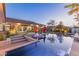 Inviting backyard pool with tanning deck, lounge chairs, umbrellas and a well manicured yard in a modern home at dusk at 274 Chartan Ave, Las Vegas, NV 89183