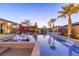 An attractive pool with underwater lights set among palm trees and lush grass for a relaxing backyard oasis at 274 Chartan Ave, Las Vegas, NV 89183