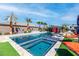 Backyard pool and spa area boasts palm trees, sunbeds, lounge chairs and clear blue skies at 274 Chartan Ave, Las Vegas, NV 89183