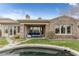 Aerial view of backyard, inground spa, covered patio, and stone exterior home at 2822 Soft Horizon Way, Las Vegas, NV 89135
