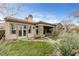 Backyard view of stone exterior home, covered patio, and backyard spa at 2822 Soft Horizon Way, Las Vegas, NV 89135