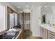 Well lit bathroom featuring a soaking tub, glass shower, and double sink vanity at 2822 Soft Horizon Way, Las Vegas, NV 89135