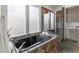Spa-like bathroom with a black soaking tub, walk-in shower, and frosted windows for privacy at 2822 Soft Horizon Way, Las Vegas, NV 89135